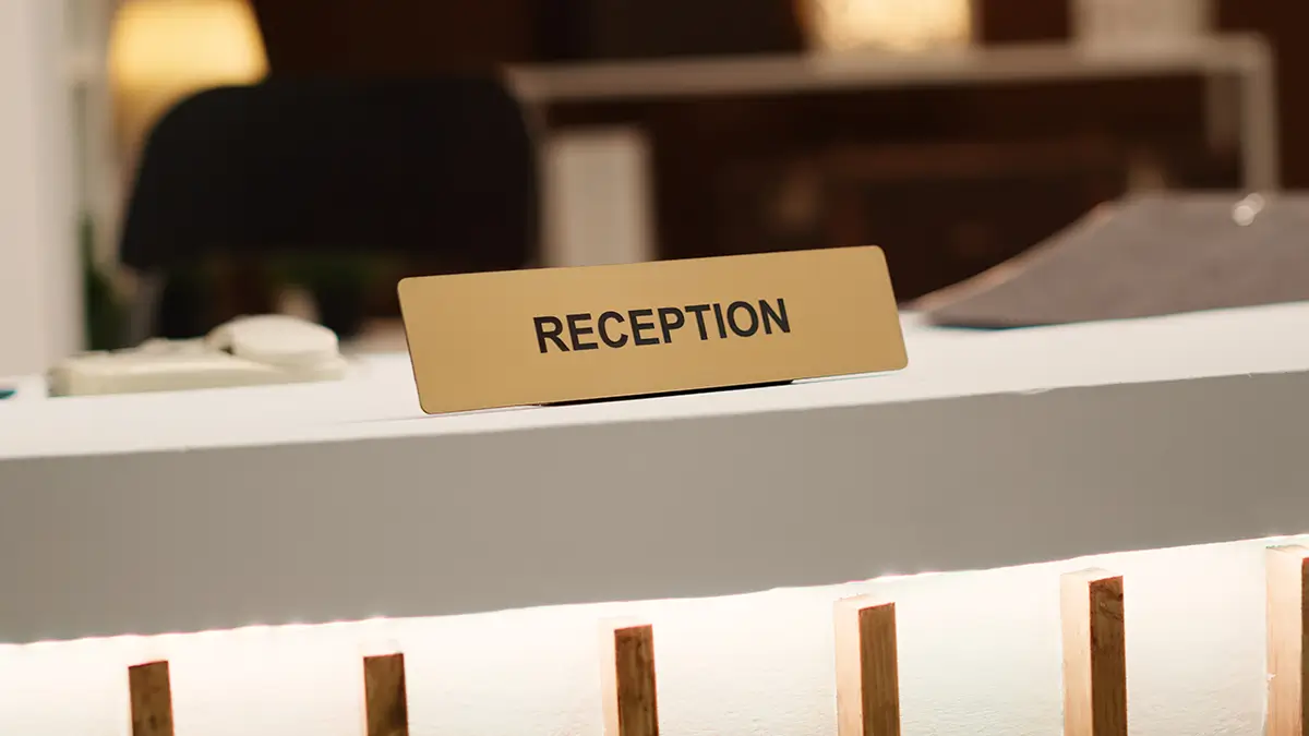 Blurry close up reception desk for hotel reservations or enquiries